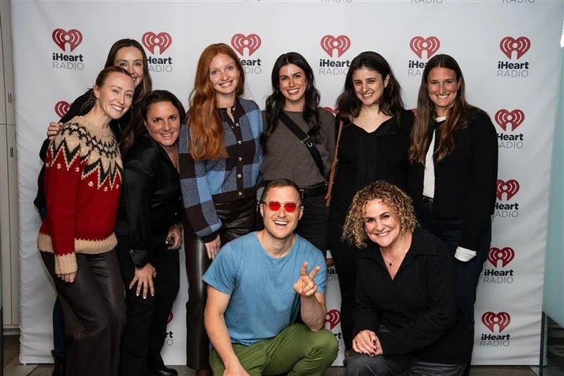 OpAD Media employees attending an iHeart Media event posing with musician Mike Posner