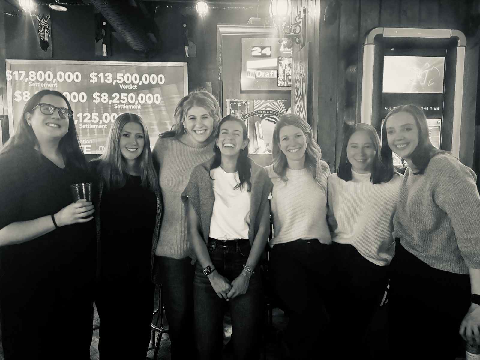 OpAD Media employees at a team event watching live sports at a happy hour event
